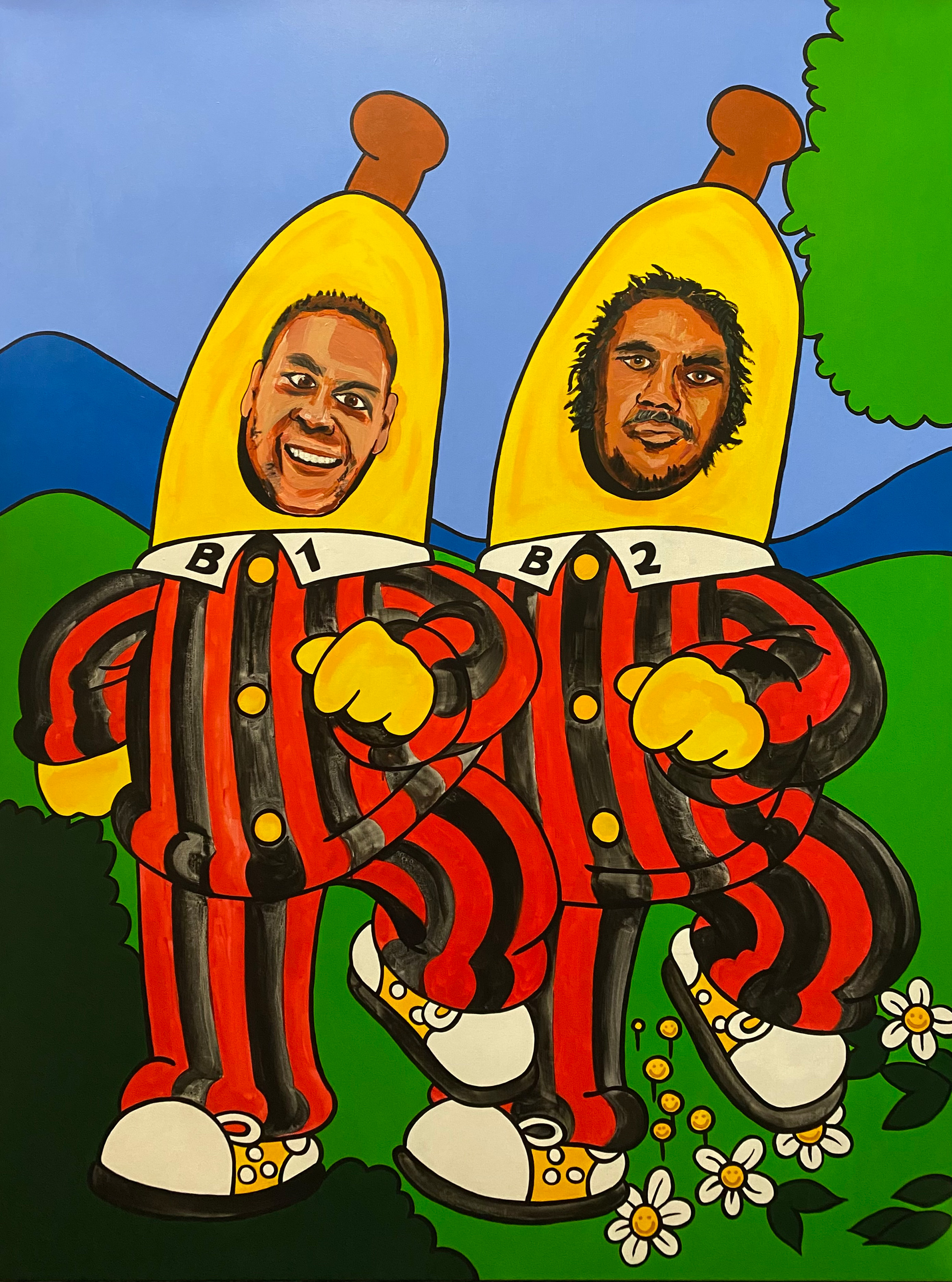 A bright painting of two Indigenous Australian men poking their heads through a life-size cut out of Bananas in Pajamas.