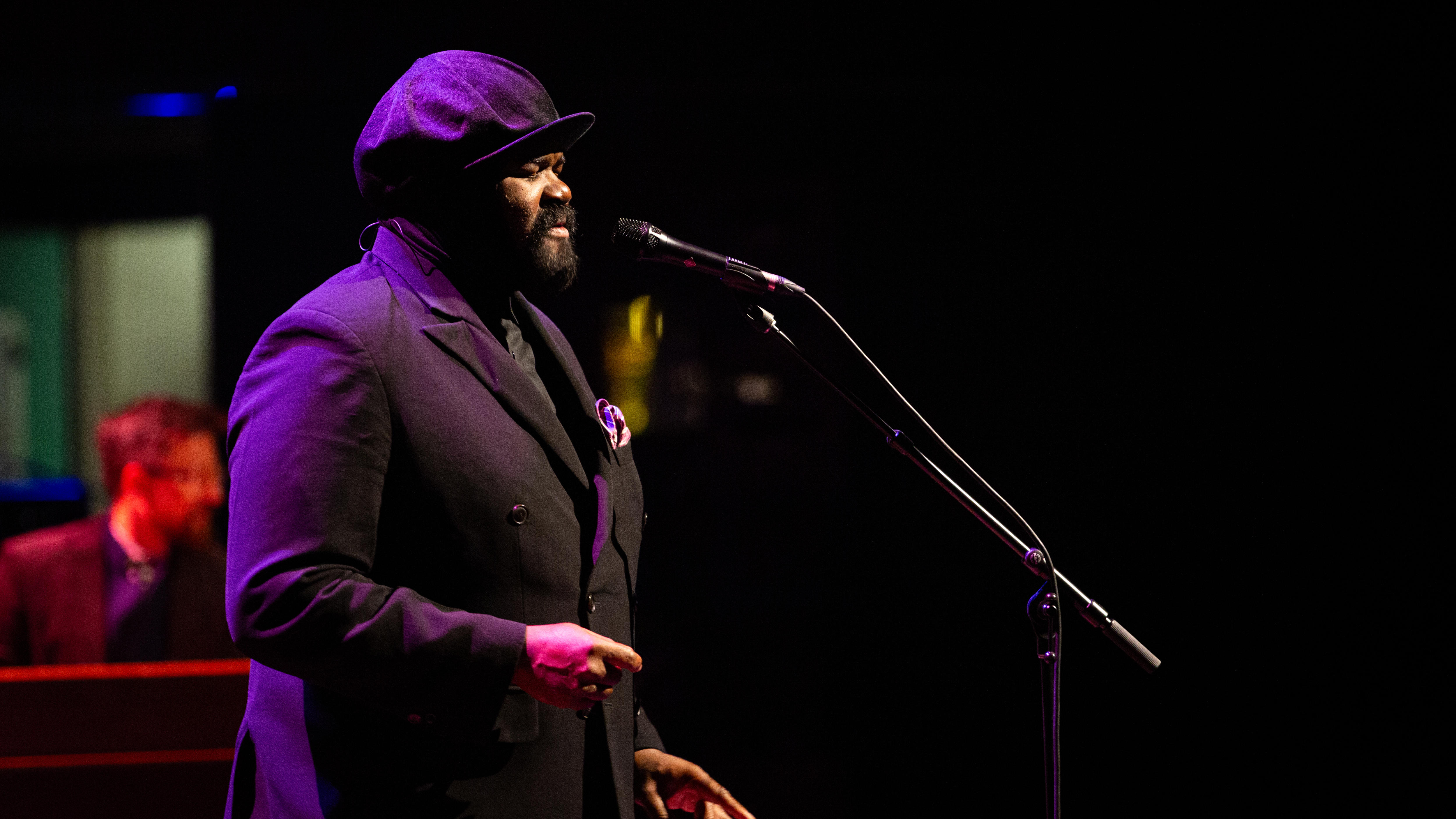 Gregory Porter at Hamer Hall performing in a dark suit and his iconic cap