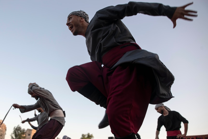 Men dancing in Gaza City.