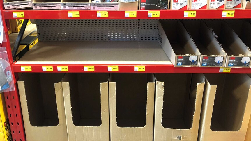 Empty shelves and boxes labelled face masks in Bunnings Warehouse