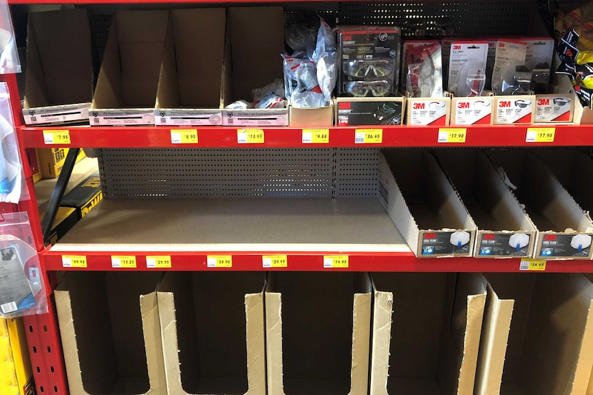 Empty shelves and boxes labelled face masks in Bunnings Warehouse