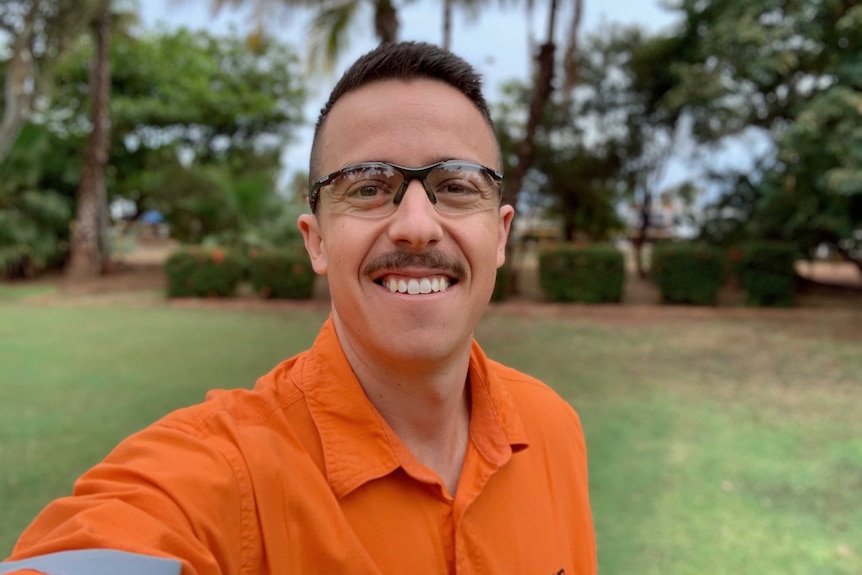 Matt Nicholas, project superintendent at BHP Port Hedland, smiling in a selfie in front of a garden.