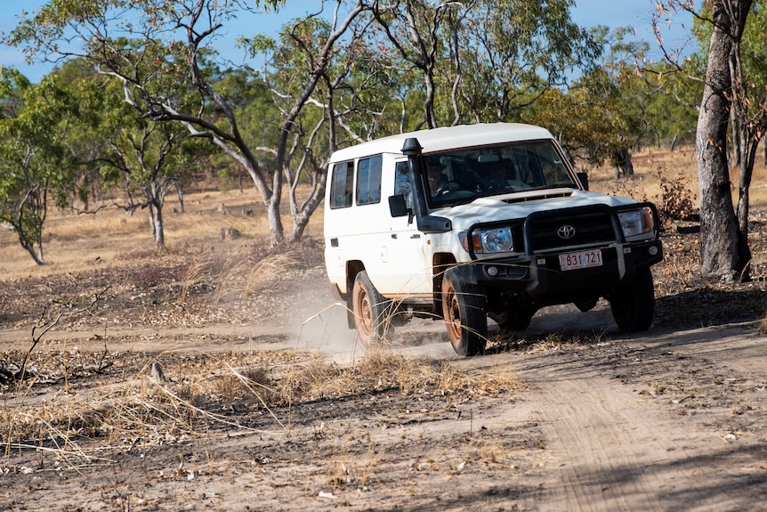 A troopy travels along a dirt path.
