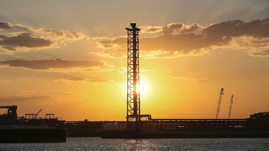 An offshore oil field against the sunrise or sunset on the Caspian Sea.