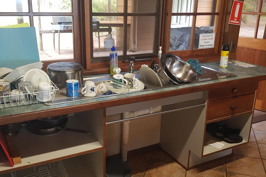 Dishes piled high in sink