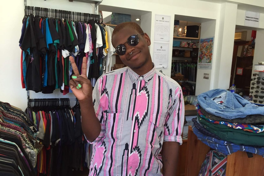 Shamir Bailey poses, doing a peace sign