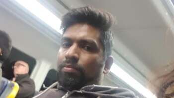 A phone shot of a man on a train.