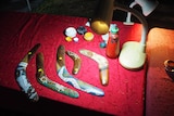 A table of boomerangs under a small light.