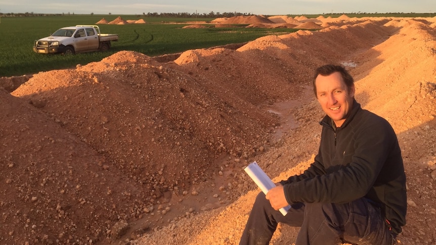 Bob Nixon, sitting on a pile of lime dug from his worst performing paddock on his WA farm.