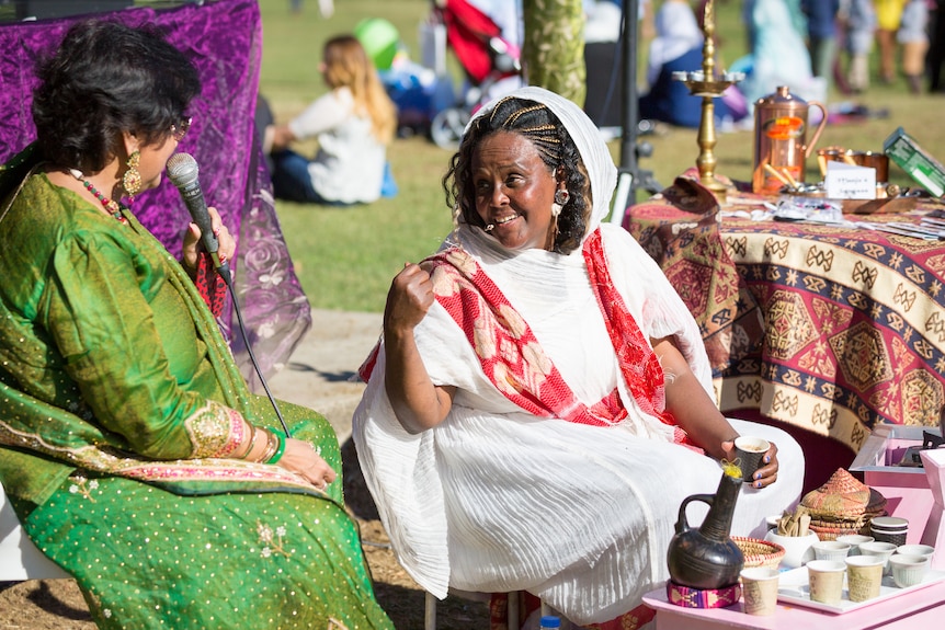 Two women speak at a multicultural festival 