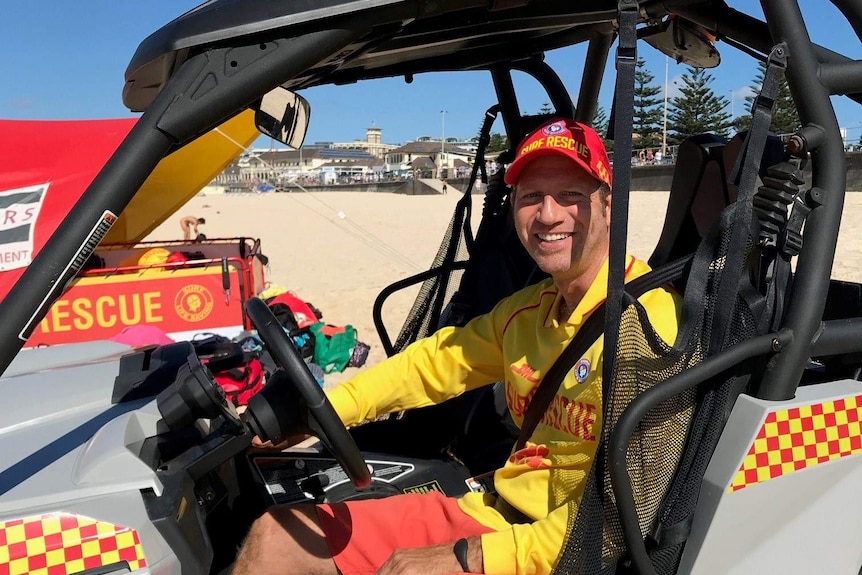 Lifesaver Doron Milner sits in the surf lifesaving buggy at Bondi.