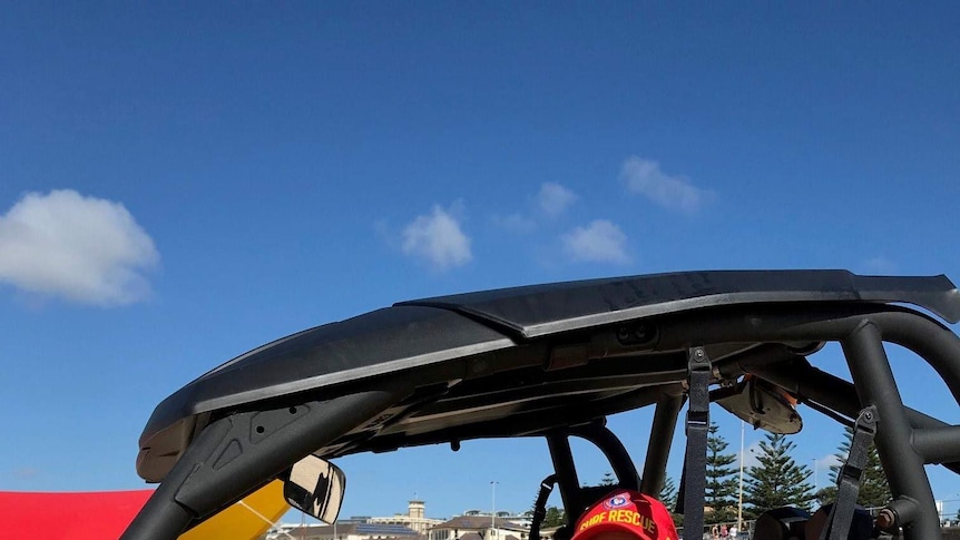 Lifesaver Doron Milner sits in the surf lifesaving buggy at Bondi.