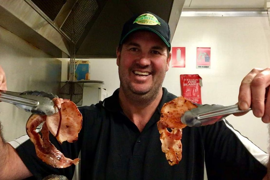 Butcher holds bacon
