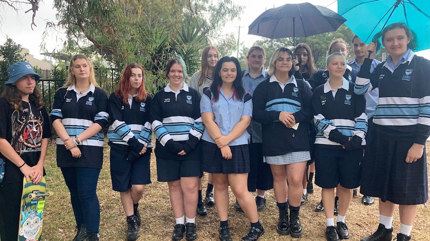 A group of students pose in school uniform.