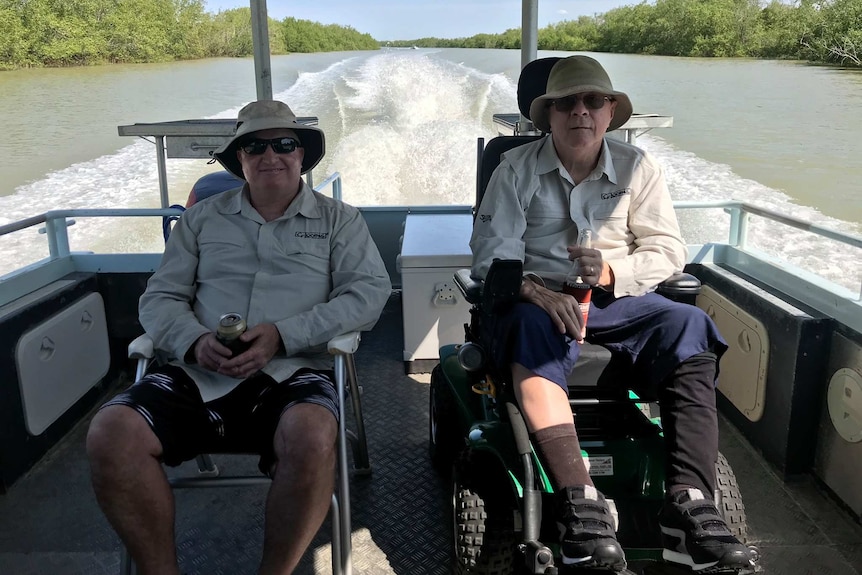 Man in wheelchair with son on boat.