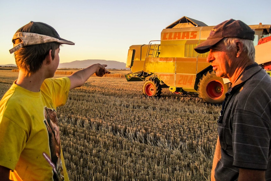 Heather's son Tom and husband Bruce at harvest on their farm.