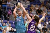 Australian basketball star Lauren Jackson prepares to go for a shot from distance as a defender stands ground.