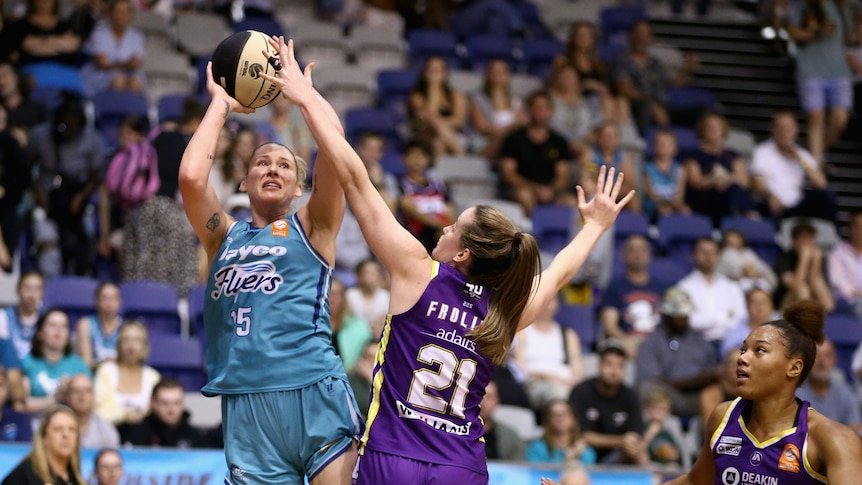 Australian basketball star Lauren Jackson prepares to go for a shot from distance as a defender stands ground.
