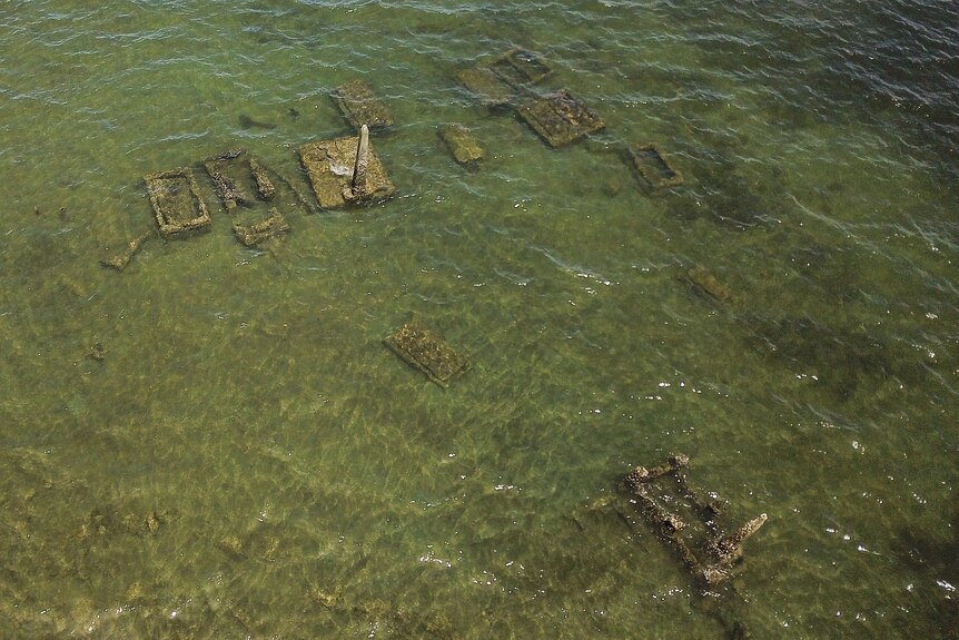 an aeria view of several tombs under water off the coast of Fiji