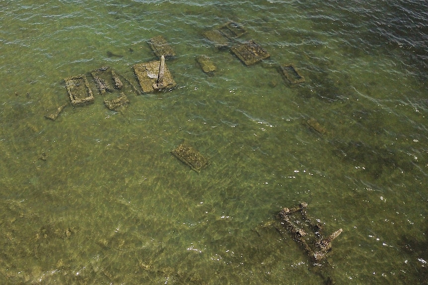 an aeria view of several tombs under water off the coast of Fiji