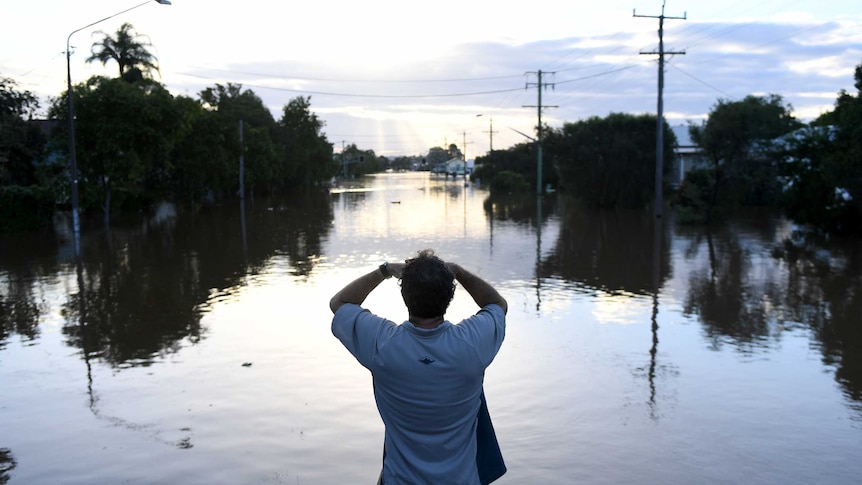 Residents watch the flood waters in Lismore, New South Wales, Friday, March 31, 2017.