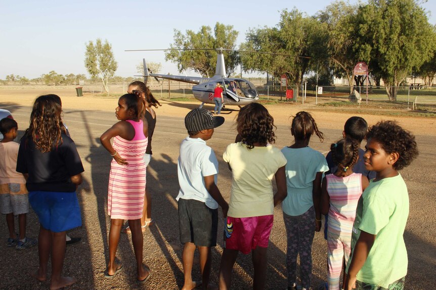 Children in Urandangi waiting for a helicopter carrying presents to be unloaded