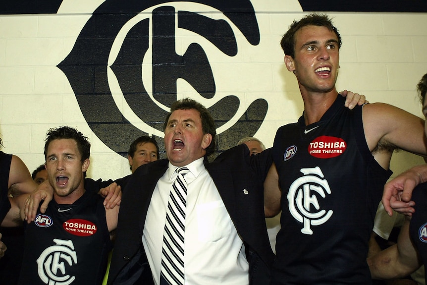 Carlton football players and their coach sing the theme song in the dressing room after a win.