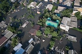 A view from above of water surrounding houses.