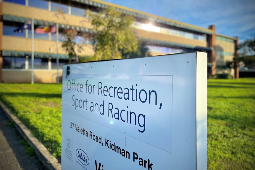 A sign for the SA Office of Recreation, Sport and Racing stands outside a building