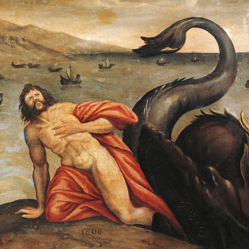 Biblical figure Jonah is wrapped in an orange cloth, kneeling on some rocks and sea monster is behind him.