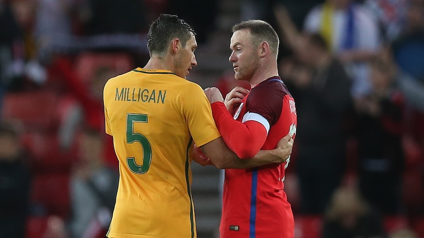 Socceroos' Mark Milligan speaks to England's Wayne Rooney after a football match between Australia and England.