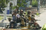 Soldiers ride on an armoured vehicle along a street in Osh, southern Kyrgyzstan