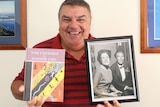 Glenn Miller holds a book called The Legends Of Moonie Jarl and a photo of his mother and uncle taken in the 1960s.