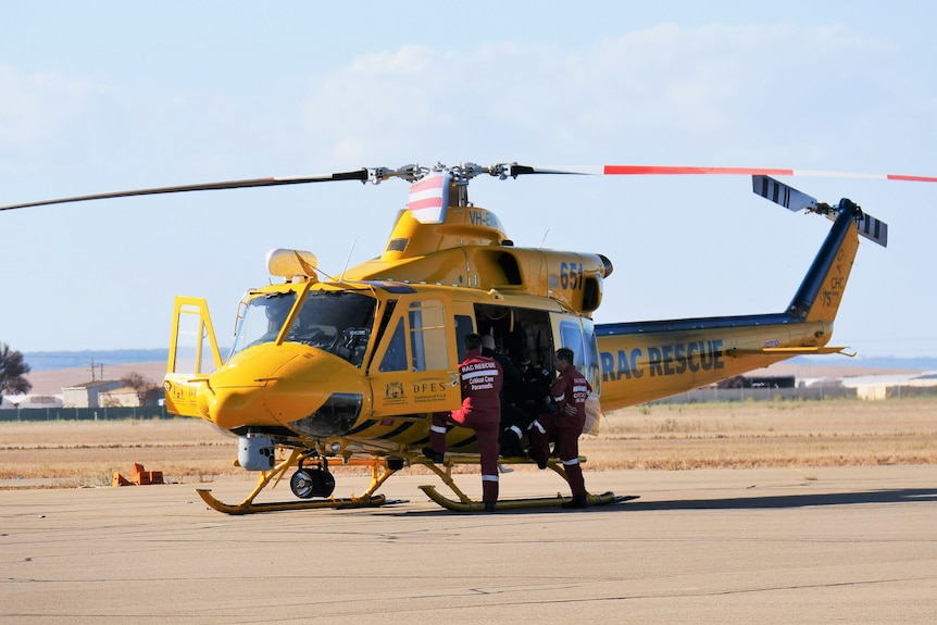 yellow rescue chopper with emergency teams waiting