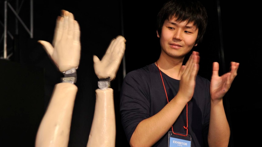 Onzu claps its hands at the opening of the annual Digital Contents Expo in Tokyo