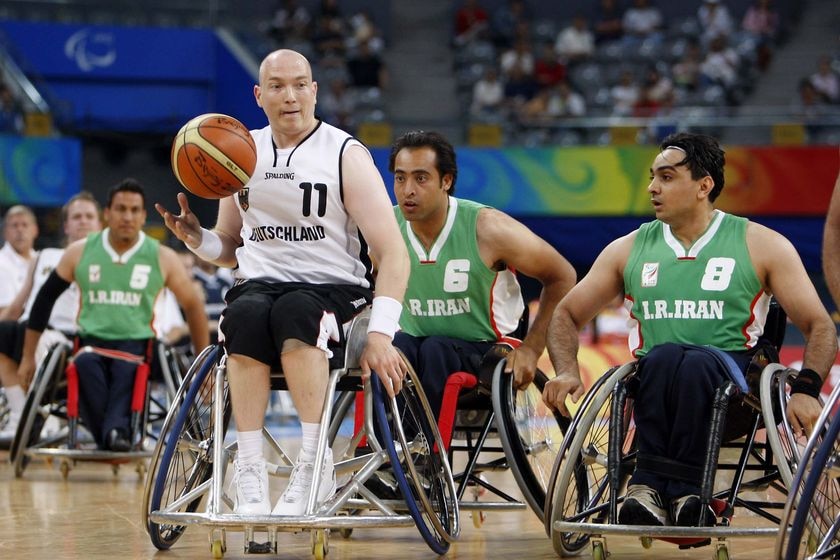 Germany's Dirk Passiwan is chased by Iran's Zakaria Hesamy Zadeh and Hakim Mansouri