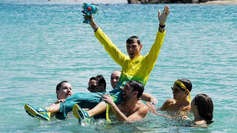 Dane Bird-Smith of Australia is thrown in the ocean by his friends