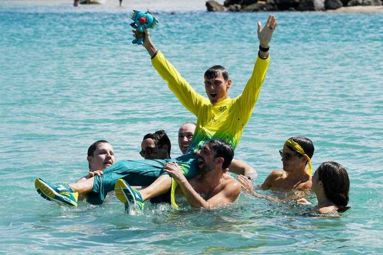 Dane Bird-Smith of Australia is thrown in the ocean by his friends