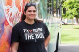Lani Pomare posing with the Regional Youth Support Services bus