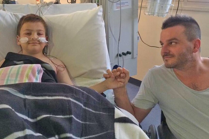 Harrison and his father Brad in the hospital ward