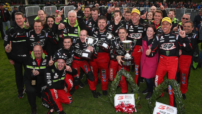 Warren Luff and Garth Tander (caps) celebrate with the Holden Racing Team after winning the Sandown 500.