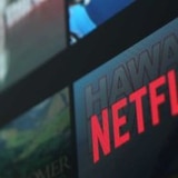 The red Netflix logo on a screen with other shows.