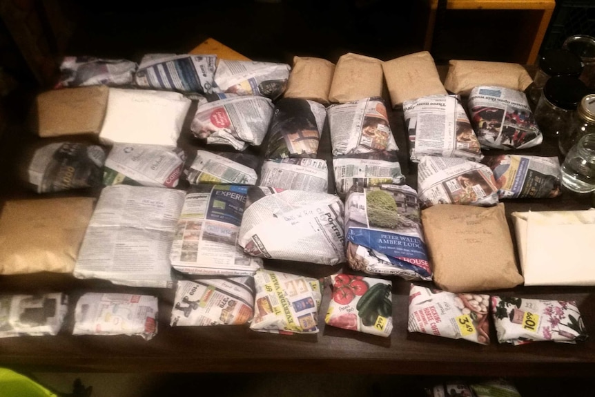 Packages of dehydrated food wrapped in newspaper for the kayaking trip.