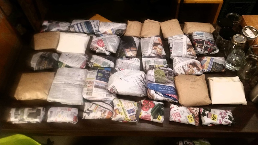 Packages of dehydrated food wrapped in newspaper for the kayaking trip.