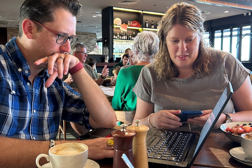 Dan Bourchier and Steph Boltje sit in a cafe