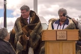 Mayor of Bathurst, Gary Rush, wrapped in possum skin cloak with several indigenous leaders