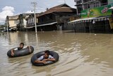 Men wade along a flooded street at Kalay township at Sagaing division