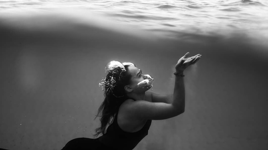 An underwater shot of a woman swimming