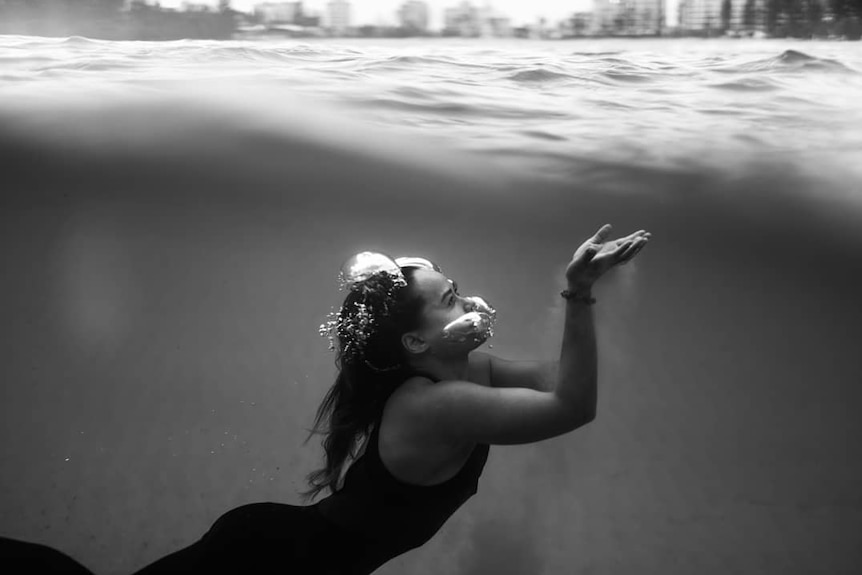 An underwater shot of a woman swimming