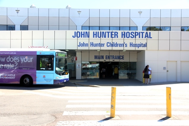 A bus drives past the entrance to Newcastle's John Hunter Hospital.